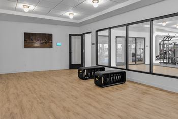 A room with a wooden floor and a painting on the wall.